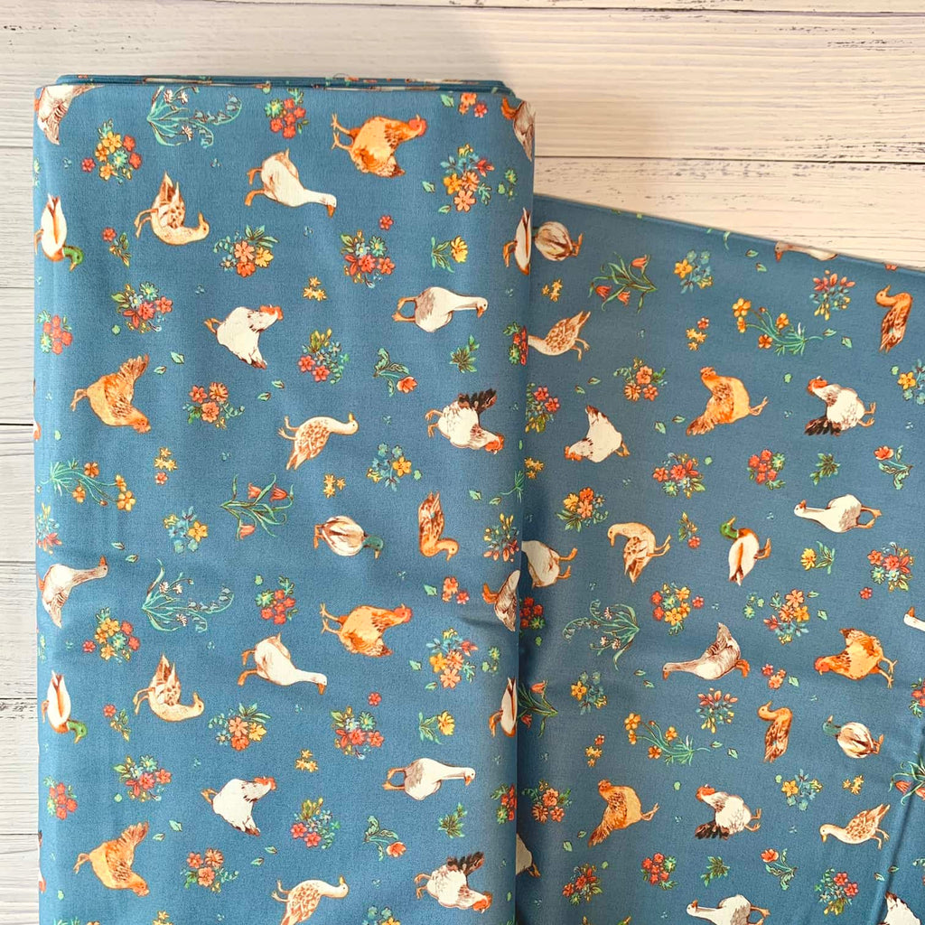 a bolt of quilting fabric that featured chickens, geese, and ducks, repeated over a blue background.